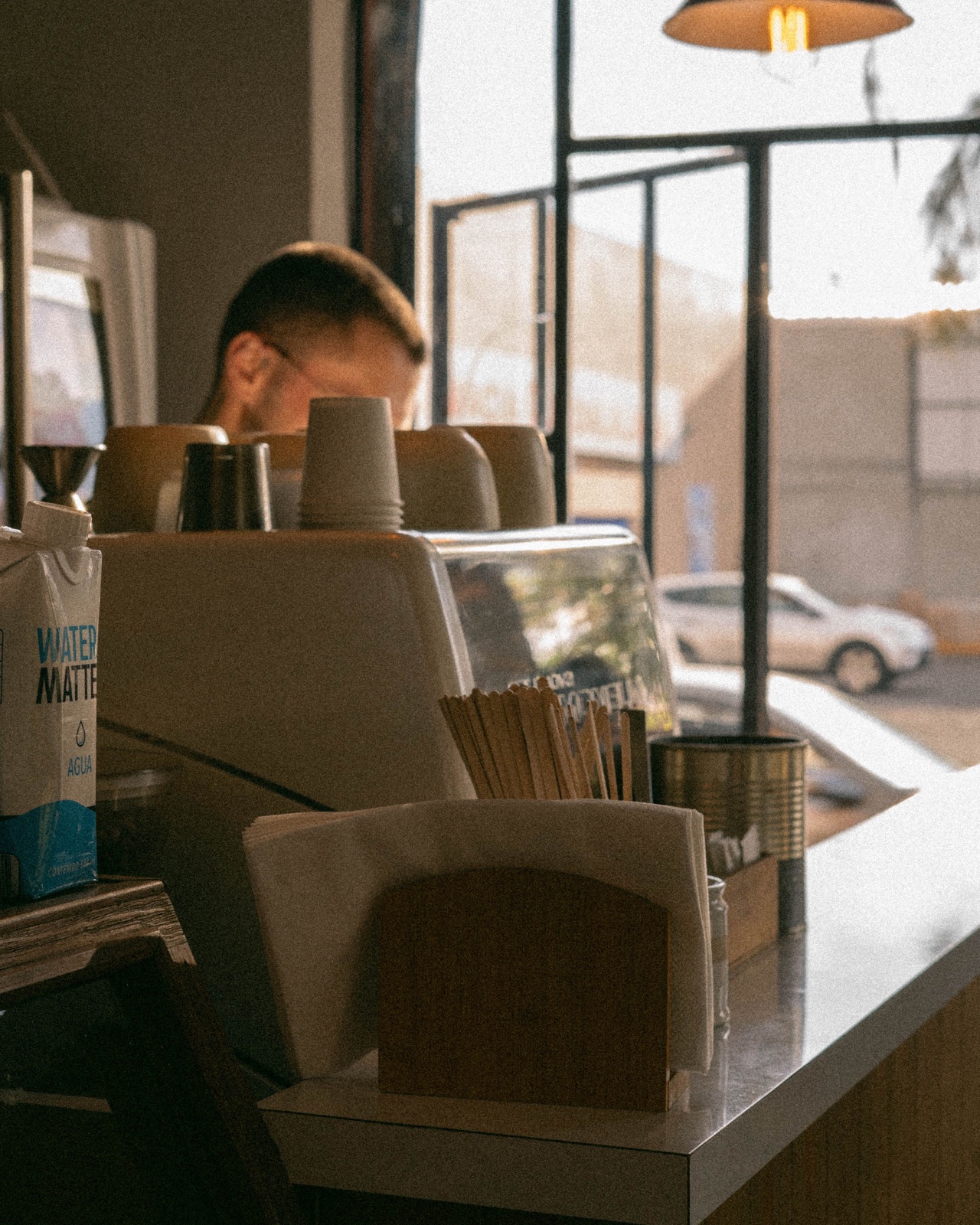 A barista working behind a café counter